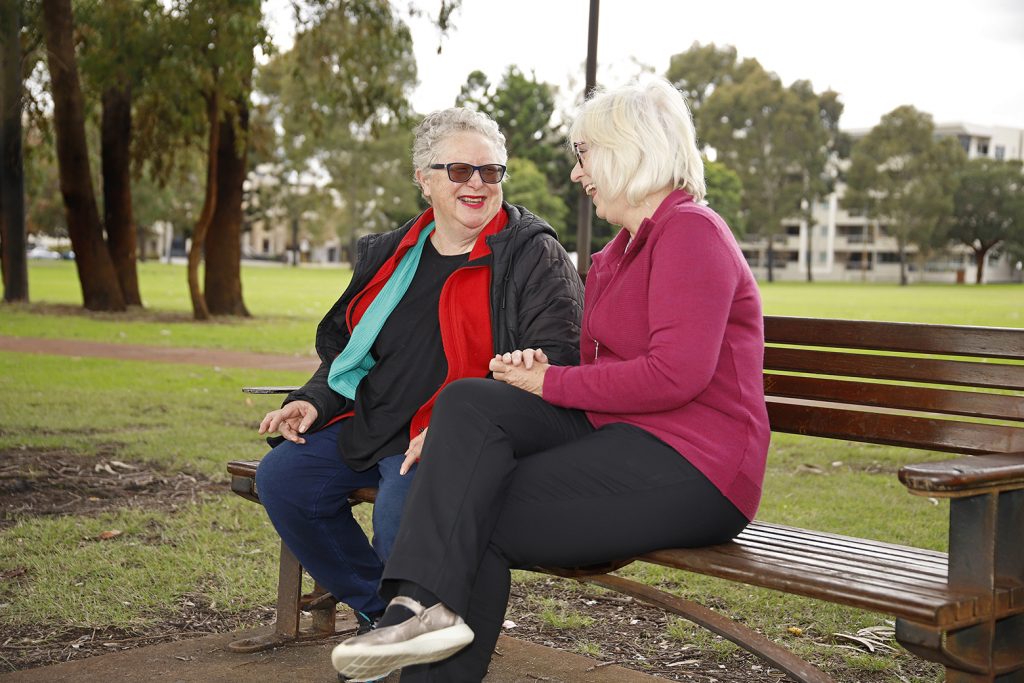 Two older women sat on park bench