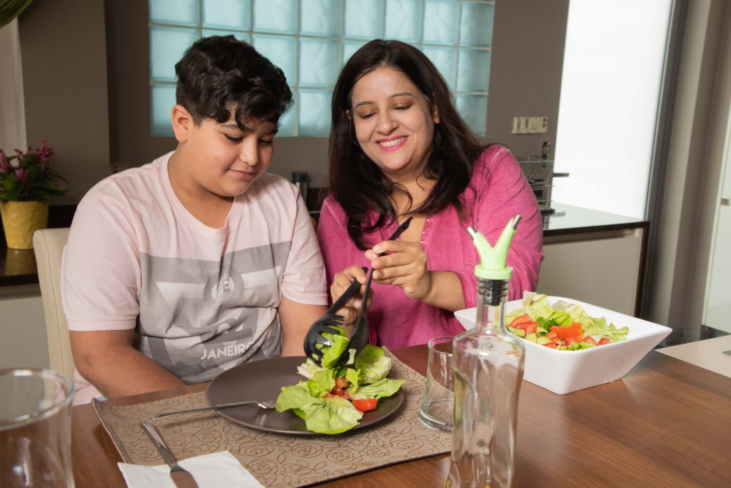 mother and son eating salad