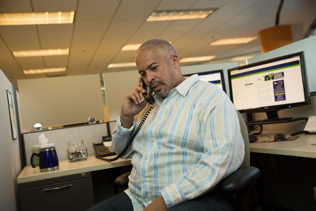 Man at office desk talking on the phone